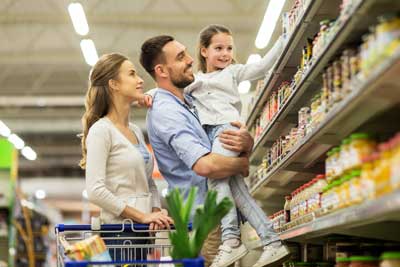 Man woman and child in grocery store aisle