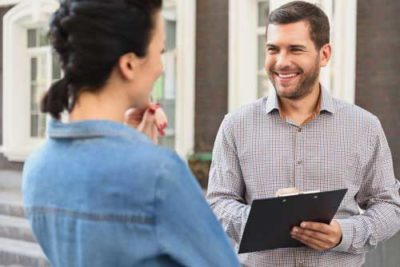 Smiling property manager with clipboard