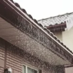 Rain flowing off of a roof during a hurricane.