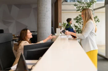 Hotel guest speaking with front desk employee in North Carolina hotel