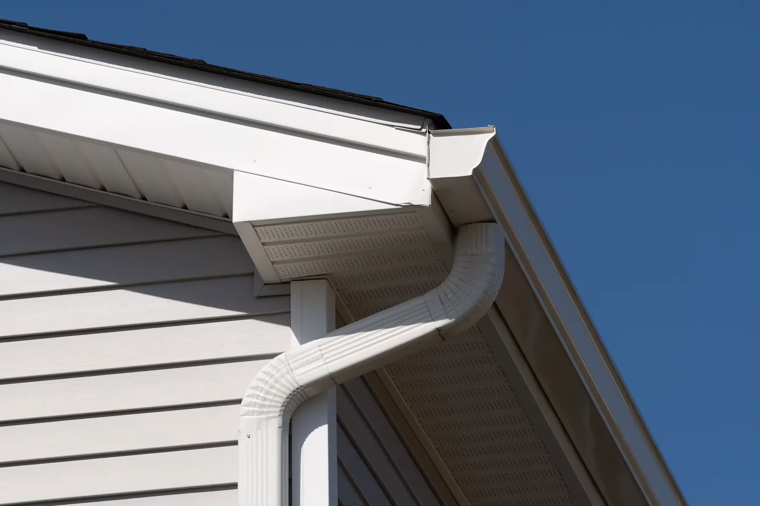 Side of a white house with a gutter system