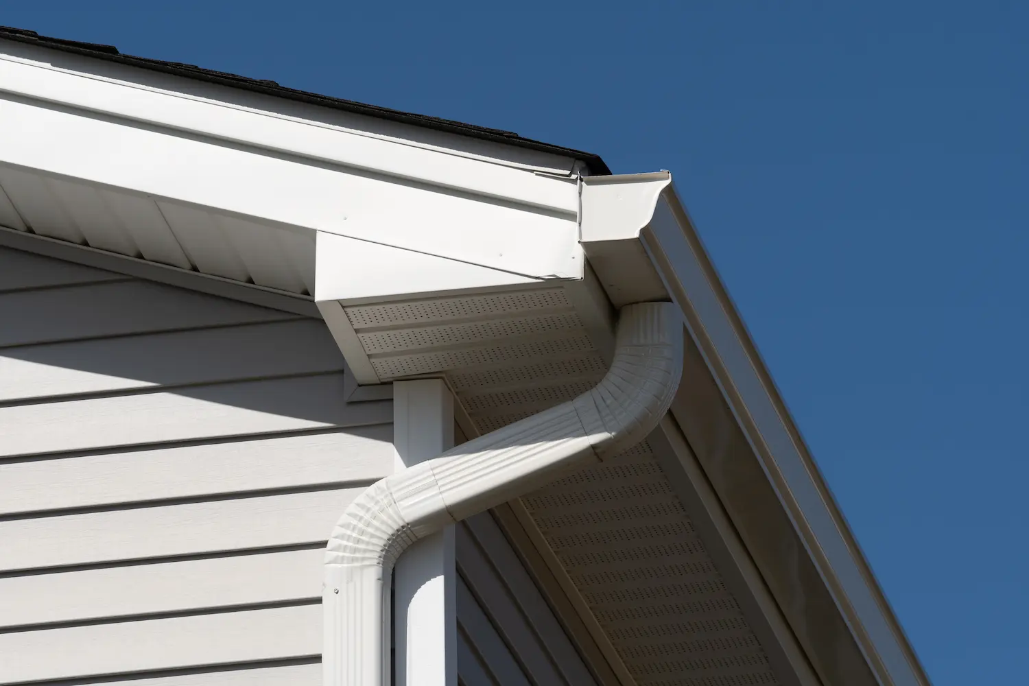 Side of a white house with a gutter system