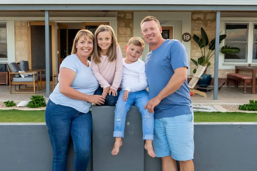 A happy family in the backyard of their North Carolina home after termite treatment. Find out how Bug Out administers termite treatment safely and effectively.