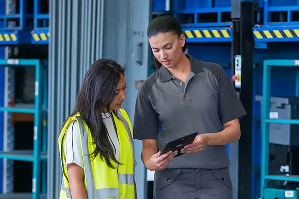 Technician speaking with warehouse manager