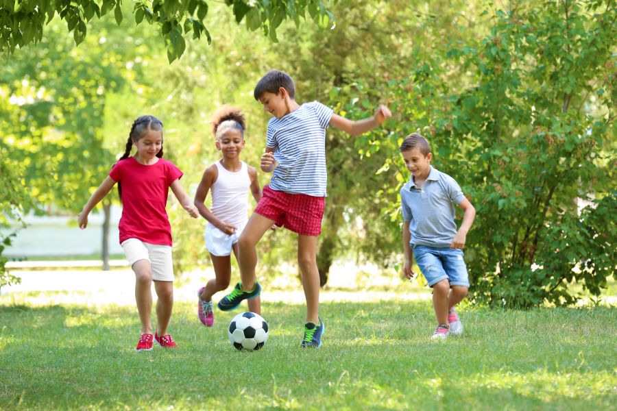 Children playing soccer outside